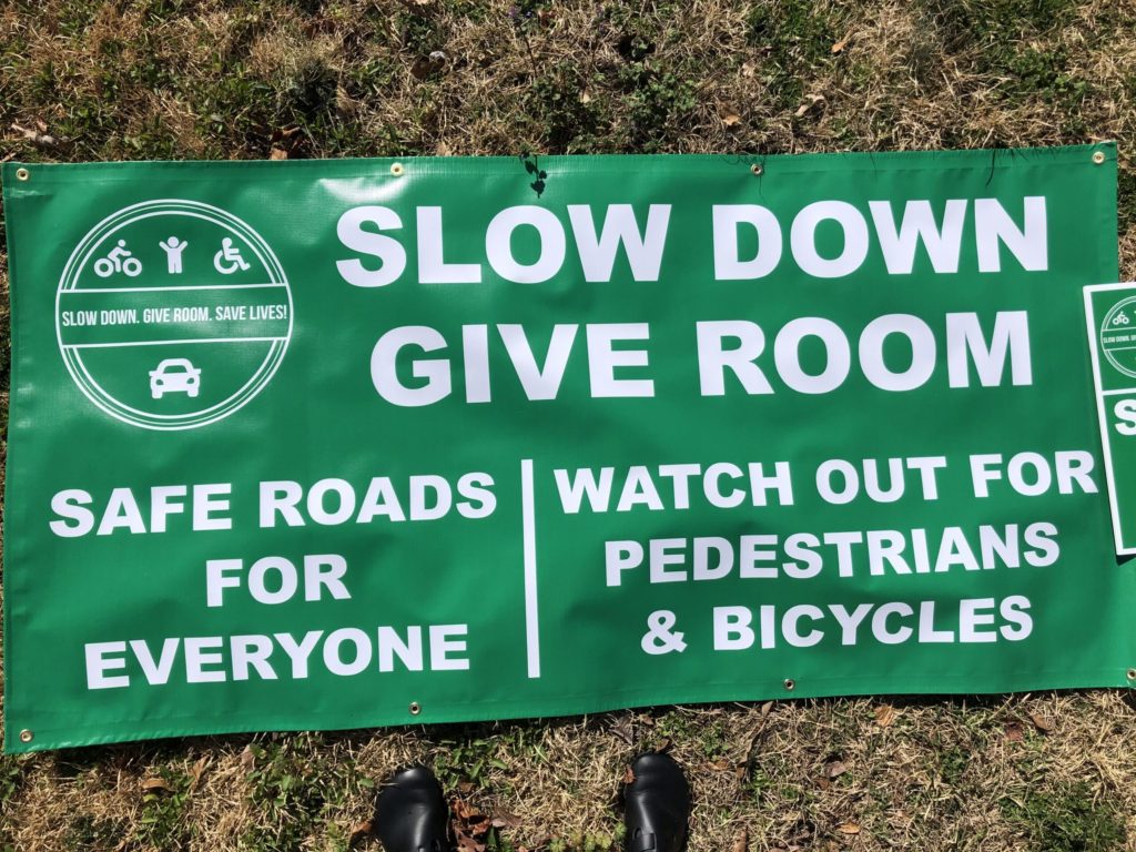 Slow Down. Give Room. public awareness campaign sign